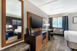 a hotel room with a bed and a desk and a mirror at Best Western Atlanta-Marietta Ballpark Hotel in Atlanta