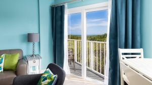 a bedroom with a view of the ocean from a balcony at Boho Chic Ocean Pointe 3214 in Key Largo