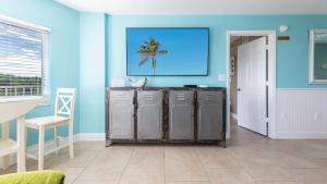 a blue room with a bunch of old metal lockers at Boho Chic Ocean Pointe 3214 in Key Largo +55 photos