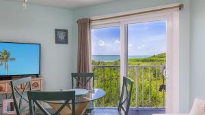 a dining room with a view of the ocean at Aqua Vista Ocean Pointe 3307 in Key Largo