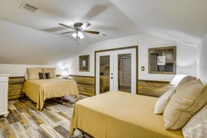 a bedroom with two beds and a ceiling fan at Hot Tub and Fire Pit Possum Kingdom Lake Retreat! in Strawn