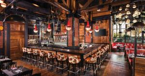a bar with a lot of chairs and lights at The LINQ Hotel and Casino in Las Vegas