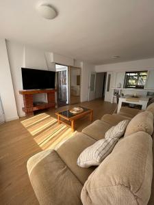 a living room with a couch and a flat screen tv at Apartamento los jazmines in Roquetas de Mar