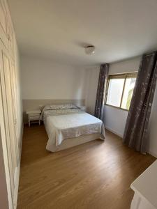 a bedroom with a bed and a window at Apartamento los jazmines in Roquetas de Mar +12 photos