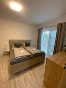 Postel nebo postele na pokoji v ubytování Apartmány Hodonín