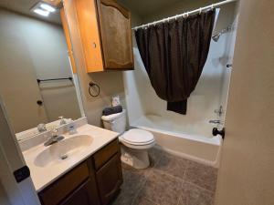 a bathroom with a sink and a toilet and a shower at Grisham's View Condo: Central Condo with a Golf Course View! in Ruidoso +51 photos