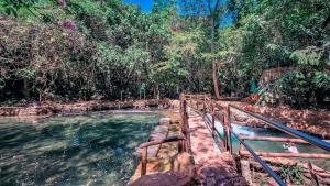 a plunge pool in a river in a forest at Apartamento de 4 Quartos Cobertura Com Área de Lazer in Rio Quente +57 photos