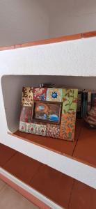 two boxes sitting on top of a shelf at Apartamento Neptuno in Benagil