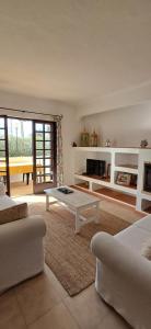 a living room with a couch and a coffee table at Apartamento Neptuno in Benagil