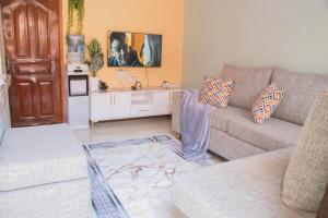 a living room with a couch and a table at Zuri Home-Kimana in Kimana