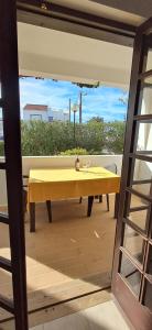 a yellow table with a yellow table cloth on a patio at Apartamento Neptuno in Benagil