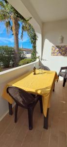 a dining table with a yellow table cloth on it at Apartamento Neptuno in Benagil