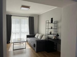 a living room with a couch and a table at Apartmán v centre mesta in Žilina