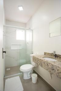 a bathroom with a toilet and a sink and a shower at Pousada Doce Encanto in Florianópolis +91 photos