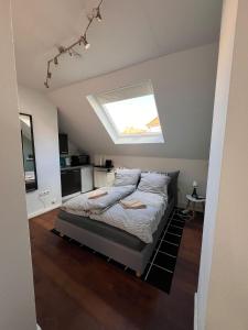 a bedroom with a bed with a skylight at Apartment 1,2,3 in Osnabrück