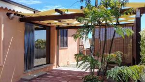 a house with a patio with awning on it at Maria Teresa's Large Open space indipendent in Cardedu