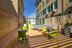 a balcony with a table and chairs and a couch at Hotel Doria in Genoa