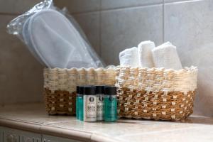 a basket sitting on a bathroom counter with toiletries at Helios Residence by A&D Properties in Porto Rafti