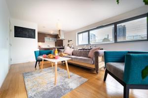 a living room with a couch and a table at Chic property near Tower Hill with a gym in London