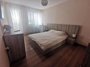 a bedroom with a bed and a wooden floor at Luxurious flat - Pleven center in Pleven