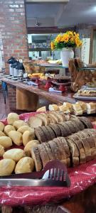 a bunch of breads and other foods on display at Pousada Sonho Meu Foz in Foz do Iguaçu
