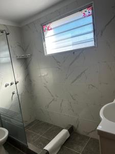 a bathroom with a shower and a sink and a window at De la Torre Apart Villa María in Villa María +38 photos