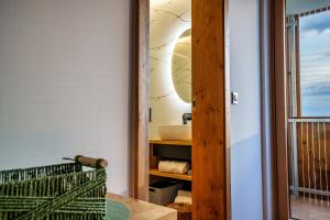 a bathroom with a sink and a mirror at Hotel Frost in Maribor