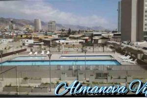 a view of a swimming pool in a city at Almanova Sunset in Antofagasta