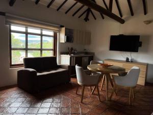 a living room with a couch and a table and chairs at Hotel Aire Libre - Suite 9 in Villa de Leyva