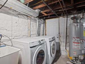 a laundry room with a washing machine and a washer at Oakland, Pittsburgh !A Modern and Stylish Private Bedroom with Shared Bathroom in Pittsburgh