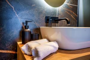 a bathroom with a sink and towels on a counter at Hotel Frost in Maribor