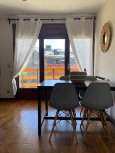 a dining room with a table and two chairs at La Muga de Llívia in Llivia