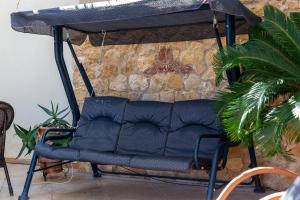 a black chair under a table in a living room at Helios Residence by A&D Properties in Porto Rafti