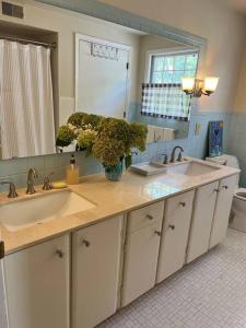 a bathroom with two sinks and a mirror at Historic Wayne Street - close to the Stadium in South Bend