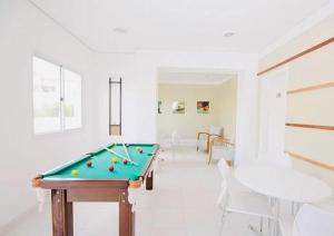 a living room with a pool table and chairs at Aeroporto de Guarulhos 2 in Guarulhos