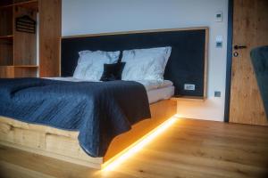 a bedroom with a bed with a black headboard at Hotel Frost in Maribor