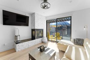 a living room with a couch and a fireplace at River West 635 by Summit County Mountain Retreats in Silverthorne