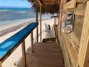 a wooden staircase leading to a beach with the ocean at Buen Hombre Kite School with Accommodations in La Costa de Buen Hombre