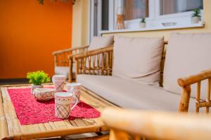 a table with a red table cloth and cups on it at Apartment Saga With Terrace And Parking - Happy Rentals in Zagreb