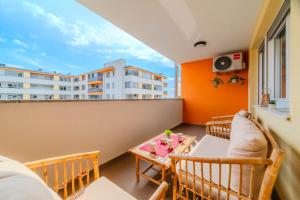 a balcony with a table and chairs and a building at Apartment Saga With Terrace And Parking - Happy Rentals in Zagreb +27 photos