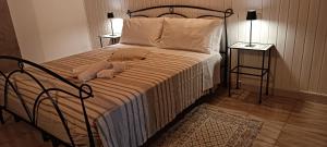 a bed with two pillows on it in a bedroom at Casa Matì in Trecastagni