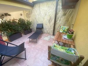a patio with a wooden table and chairs at Appartamento "Casa Anna" in Trieste +11 photos