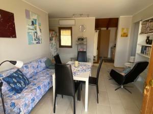 a living room with a couch and a table and chairs at Appartamento "Casa Anna" in Trieste