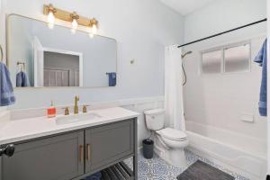 Un baño con lavabo, inodoro y espejo. en Jax Beach Getaway 5 Minute Walk to the Waves, en Jacksonville Beach 20 fotos más