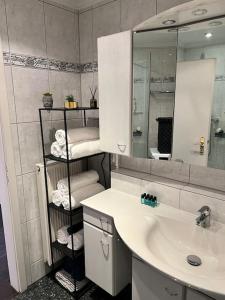 a bathroom with a sink and a mirror at Hochwertige Wohnung Frechen City in Frechen +25 photos