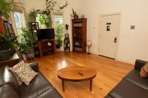 a living room with a couch and a table at 2 bedroom Boston condo in Jamaica Plain with parking in Boston