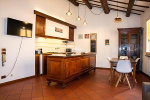 a kitchen with a counter and a table with chairs at LHE Beating Heart in Cesena