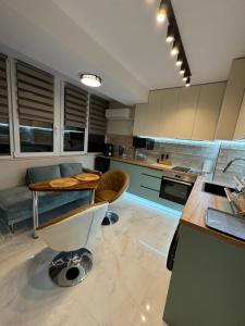 a kitchen with a island and a table in it at Bamboo tree Apartment in Vidin