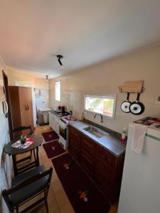 a kitchen with a sink and a table in it at Ape Vista Mar in Guarapari +14 photos