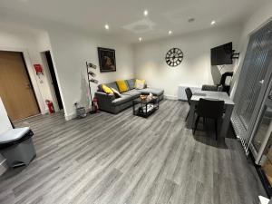 a living room with a couch and a table at Castle Glen Lodge in Dumfries
